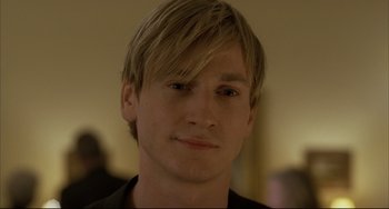 Movie still from “The Piano Teacher” (2001), directed by Michael Haneke – A person wearing a black shirt; Close Up shot, Over the shoulder angle