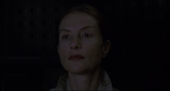 Movie still from “The Piano Teacher” (2001), directed by Michael Haneke – A person wearing a white shirt; Close Up shot, Low angle