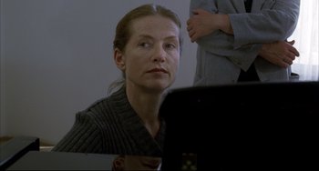 Movie still from “The Piano Teacher” (2001), directed by Michael Haneke – A woman sitting in front of a laptop computer; Close Up shot, Over the shoulder angle