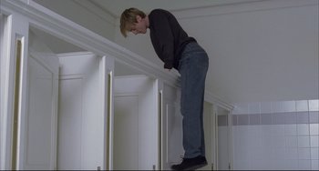 Movie still from “The Piano Teacher” (2001), directed by Michael Haneke – A man standing on the edge of a wall; Wide shot, Low angle