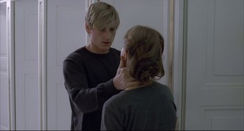 Movie still from “The Piano Teacher” (2001), directed by Michael Haneke – A man and a woman looking at each other in a mirror; Medium shot, Over the shoulder angle