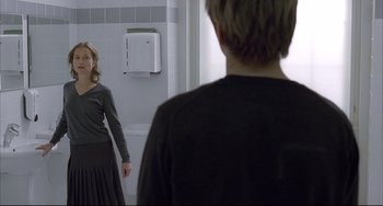 Movie still from “The Piano Teacher” (2001), directed by Michael Haneke – A man and a woman in front of a bathroom mirror; Medium shot, Over the shoulder angle
