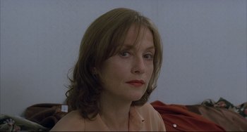 Movie still from “The Piano Teacher” (2001), directed by Michael Haneke – A person with long brown hair; Close Up shot, Over the shoulder angle