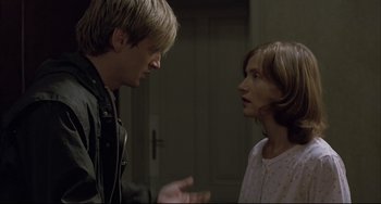 Movie still from “The Piano Teacher” (2001), directed by Michael Haneke – A man and a woman talking to each other; Close Up shot, Over the shoulder angle
