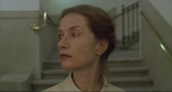 Movie still from “The Piano Teacher” (2001), directed by Michael Haneke – A person looking up at the sky; Close Up shot, Low angle