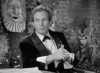 Movie still from “The Picture of Dorian Gray” (1945), directed by Albert Lewin – Black and white photograph of a man sitting at a table; Close Up shot, Over the shoulder angle
