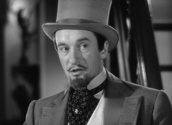 Movie still from “The Picture of Dorian Gray” (1945), directed by Albert Lewin – A black and white photo of a man wearing a top hat; Close Up shot, Low angle