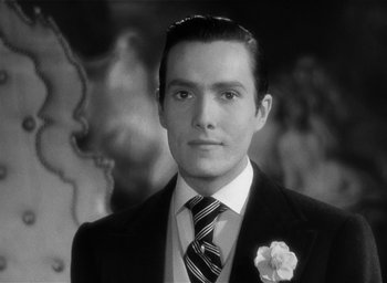 Movie still from “The Picture of Dorian Gray” (1945), directed by Albert Lewin – Black and white photograph of a man in a suit and tie; Close Up shot, Low angle