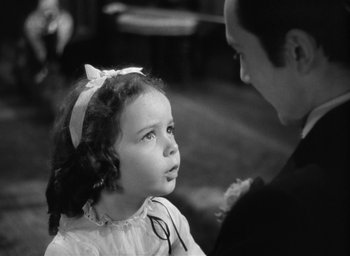 Movie still from “The Picture of Dorian Gray” (1945), directed by Albert Lewin – A little girl is looking at an older man; Close Up shot, Over the shoulder angle