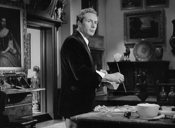 Movie still from “The Picture of Dorian Gray” (1945), directed by Albert Lewin – A black and white photo of a man painting; Medium shot, Over the shoulder angle