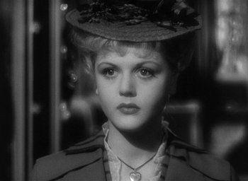 Movie still from “The Picture of Dorian Gray” (1945), directed by Albert Lewin – A black and white photo of a woman in a hat; Close Up shot, Over the shoulder angle