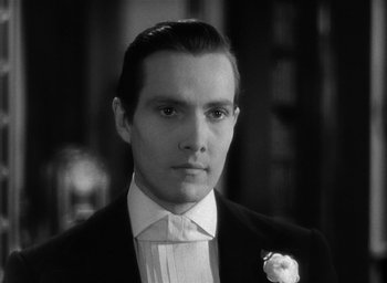 Movie still from “The Picture of Dorian Gray” (1945), directed by Albert Lewin – A black and white photo of a man in a tuxedo; Close Up shot, Low angle