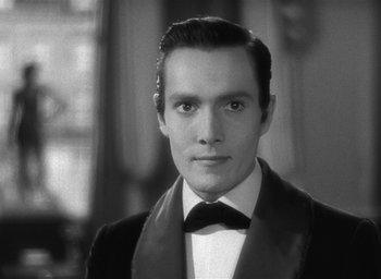 Movie still from “The Picture of Dorian Gray” (1945), directed by Albert Lewin – Black and white photograph of a man in a tuxedo; Close Up shot, Over the shoulder angle