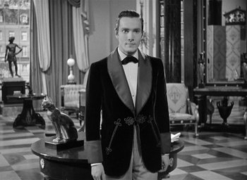 Movie still from “The Picture of Dorian Gray” (1945), directed by Albert Lewin – A man in a tuxedo standing in a living room; Medium shot, Low angle
