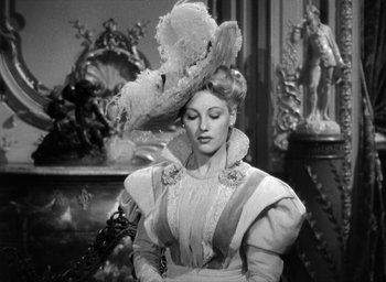 Movie still from “The Picture of Dorian Gray” (1945), directed by Albert Lewin – A black and white photo of a woman wearing a hat; Medium shot, Low angle