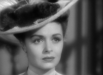 Movie still from “The Picture of Dorian Gray” (1945), directed by Albert Lewin – A black and white photo of a woman in a hat; Close Up shot, Over the shoulder angle