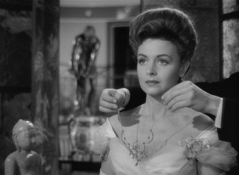 Movie still from “The Picture of Dorian Gray” (1945), directed by Albert Lewin – A black - and - white photo of a woman wearing a necklace; Close Up shot, Over the shoulder angle