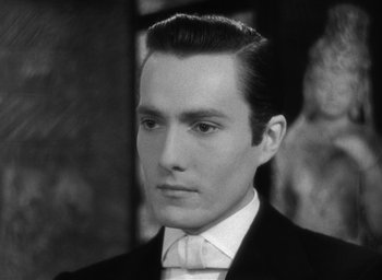 Movie still from “The Picture of Dorian Gray” (1945), directed by Albert Lewin – A black and white photo of a man in a suit; Close Up shot, High angle