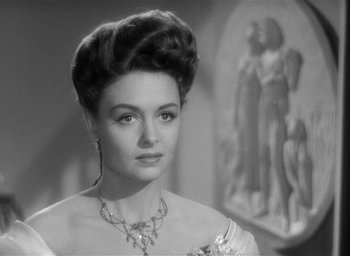 Movie still from “The Picture of Dorian Gray” (1945), directed by Albert Lewin – An old photo of a woman in a dress with a necklace; Close Up shot, Over the shoulder angle