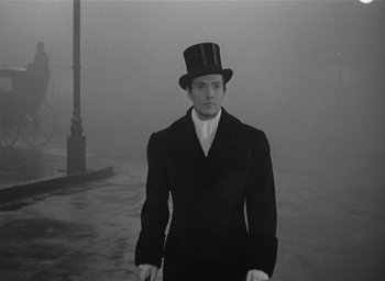 Movie still from “The Picture of Dorian Gray” (1945), directed by Albert Lewin – A man wearing a top hat and a black suit; Medium shot, Over the shoulder angle