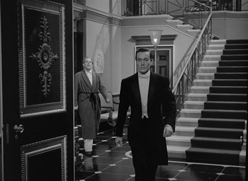 Movie still from “The Picture of Dorian Gray” (1945), directed by Albert Lewin – A man in a tuxedo walking down the hall way of a house; Wide shot, Low angle
