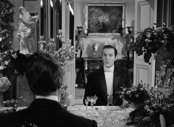 Movie still from “The Picture of Dorian Gray” (1945), directed by Albert Lewin – A black and white photo of a man and a woman sitting in front of a mirror; Medium shot, Over the shoulder angle