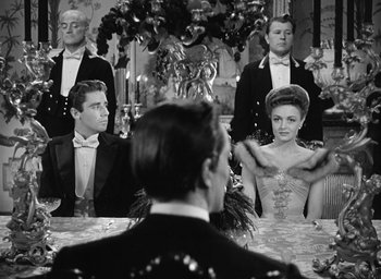 Movie still from “The Picture of Dorian Gray” (1945), directed by Albert Lewin – A man and a woman are sitting in front of a mirror; Medium shot, Over the shoulder angle