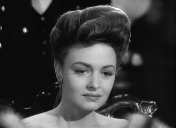 Movie still from “The Picture of Dorian Gray” (1945), directed by Albert Lewin – A black and white photo of a woman with a big hair style; Close Up shot, Over the shoulder angle