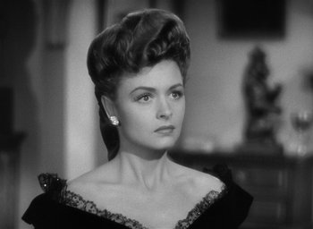 Movie still from “The Picture of Dorian Gray” (1945), directed by Albert Lewin – An old photo of a woman in a black dress; Close Up shot, Over the shoulder angle