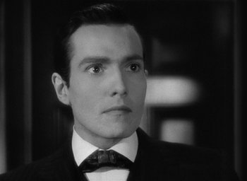 Movie still from “The Picture of Dorian Gray” (1945), directed by Albert Lewin – A black and white photo of a man in a suit and bow tie; Close Up shot, Low angle