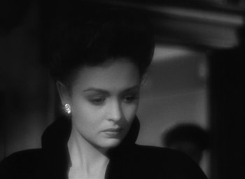 Movie still from “The Picture of Dorian Gray” (1945), directed by Albert Lewin – A black and white photo of a woman in a black jacket; Close Up shot, Over the shoulder angle