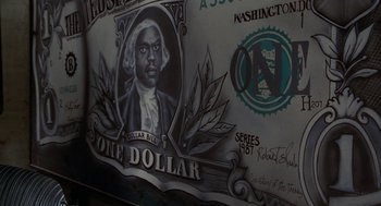 Movie still from “The Players Club” (1998), directed by Ice Cube – Picture of the face of a one dollar bill; Extreme Close Up shot, Low angle