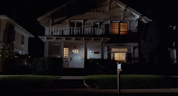 Movie still from “The Players Club” (1998), directed by Ice Cube – A night time picture of a house with a mail box; Wide shot, Low angle