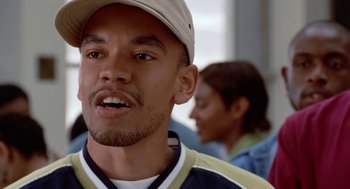 Movie still from “The Players Club” (1998), directed by Ice Cube – A person wearing a hat; Close Up shot, Low angle