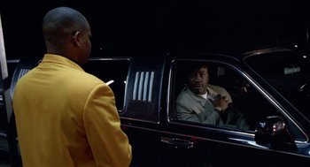 Movie still from “The Players Club” (1998), directed by Ice Cube – A man sitting in the passenger seat of a limo; Medium shot, Over the shoulder angle