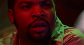 Movie still from “The Players Club” (1998), directed by Ice Cube – A man's face in a dark room; Close Up shot, Over the shoulder angle