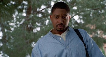 Movie still from “The Players Club” (1998), directed by Ice Cube – A person wearing a blue shirt; Close Up shot, Low angle