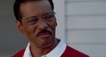 Movie still from “The Players Club” (1998), directed by Ice Cube – An older man wearing glasses and a red shirt; Close Up shot, Low angle