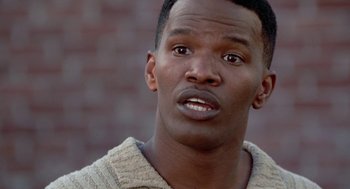 Movie still from “The Players Club” (1998), directed by Ice Cube – A person looking at the camera; Close Up shot, Over the shoulder angle