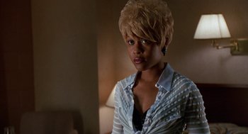 Movie still from “The Players Club” (1998), directed by Ice Cube – A woman with blonde hair wearing a striped shirt; Close Up shot, Low angle