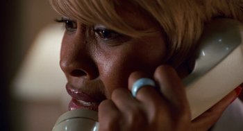 Movie still from “The Players Club” (1998), directed by Ice Cube – A person talking on a cell phone; Extreme Close Up shot, High angle