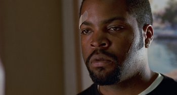 Movie still from “The Players Club” (1998), directed by Ice Cube – A person with a bandage on his head; Close Up shot, Over the shoulder angle
