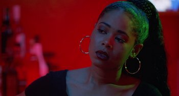 Movie still from “The Players Club” (1998), directed by Ice Cube – A beautiful young woman with a black shirt and a red background; Close Up shot, Over the shoulder angle