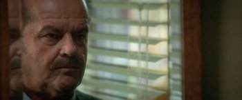 Movie still from “The Pledge” (2001), directed by Sean Penn – A man's face in front of a window; Close Up shot, Over the shoulder angle