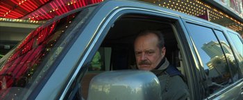 Movie still from “The Pledge” (2001), directed by Sean Penn – A man sitting in the driver's seat of a car; Close Up shot, Low angle