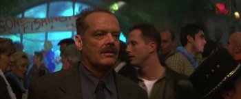 Movie still from “The Pledge” (2001), directed by Sean Penn – A man in a suit and tie standing next to another man in a suit and tie; Close Up shot, Low angle