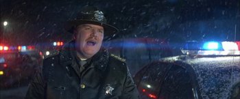 Movie still from “The Pledge” (2001), directed by Sean Penn – A man in a police officer's uniform with his mouth wide open; Close Up shot, Low angle