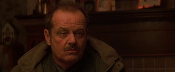 Movie still from “The Pledge” (2001), directed by Sean Penn – An older man with a mustache is sitting in a chair; Close Up shot, Over the shoulder angle