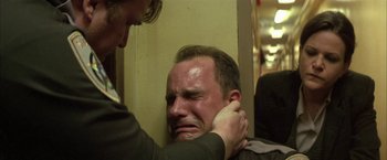 Movie still from “The Pledge” (2001), directed by Sean Penn – A man with his hands around his neck; Close Up shot, Over the shoulder angle