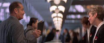 Movie still from “The Pledge” (2001), directed by Sean Penn – A person is holding a book in front of a row of lights; Close Up shot, Low angle